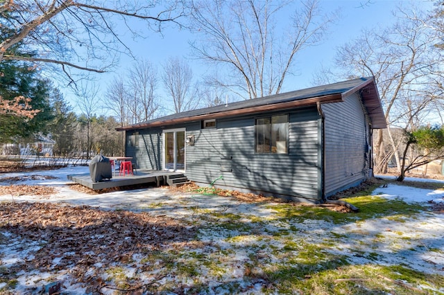 rear view of property featuring a wooden deck