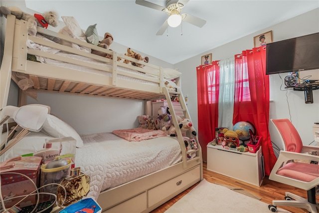 bedroom with a ceiling fan and wood finished floors