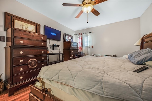 bedroom with a ceiling fan and wood finished floors