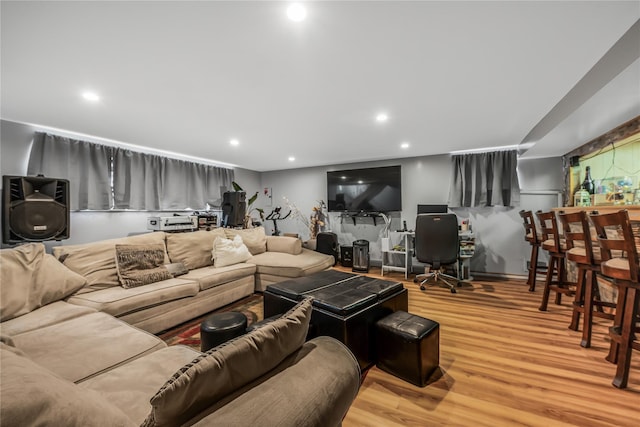 living area featuring a dry bar, wood finished floors, and recessed lighting