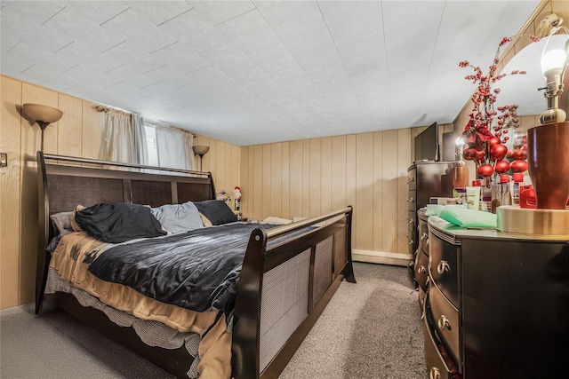 bedroom with carpet flooring and wood walls