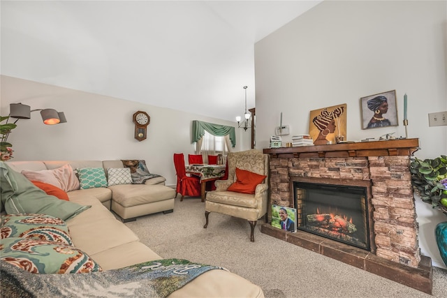 carpeted living area featuring high vaulted ceiling, a fireplace, and a chandelier