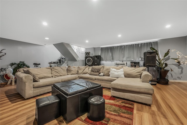 living room featuring light wood-style flooring, baseboards, and recessed lighting