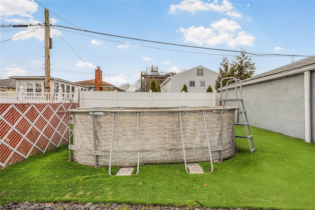 view of yard with a pool and a fenced backyard