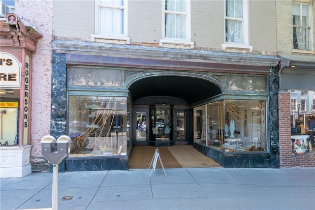 view of exterior entry with brick siding