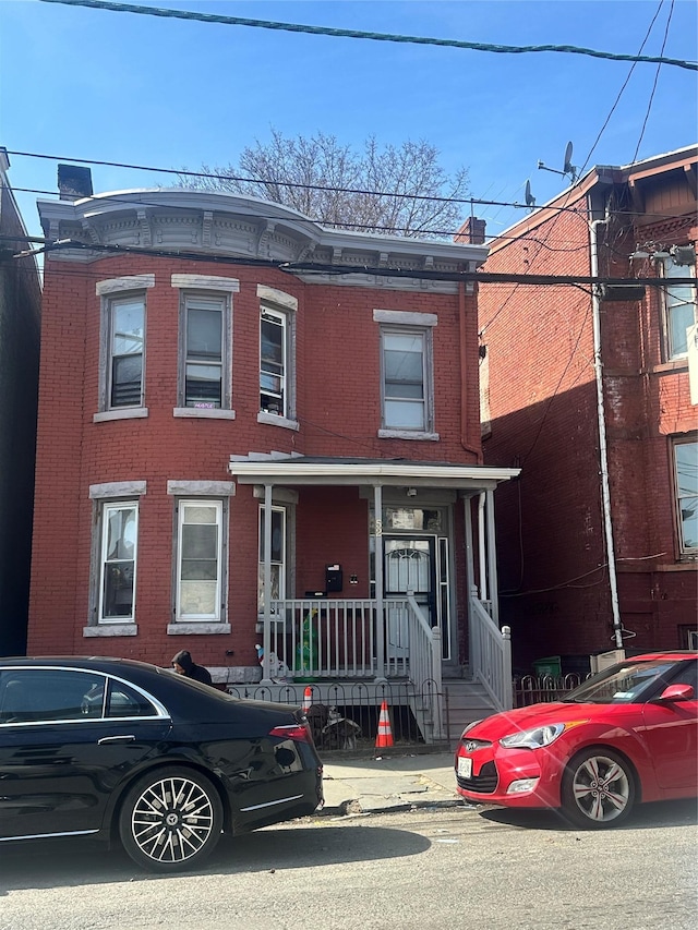 52 Lander St, Newburgh, NY 12550 - view of property with brick siding and covered porch