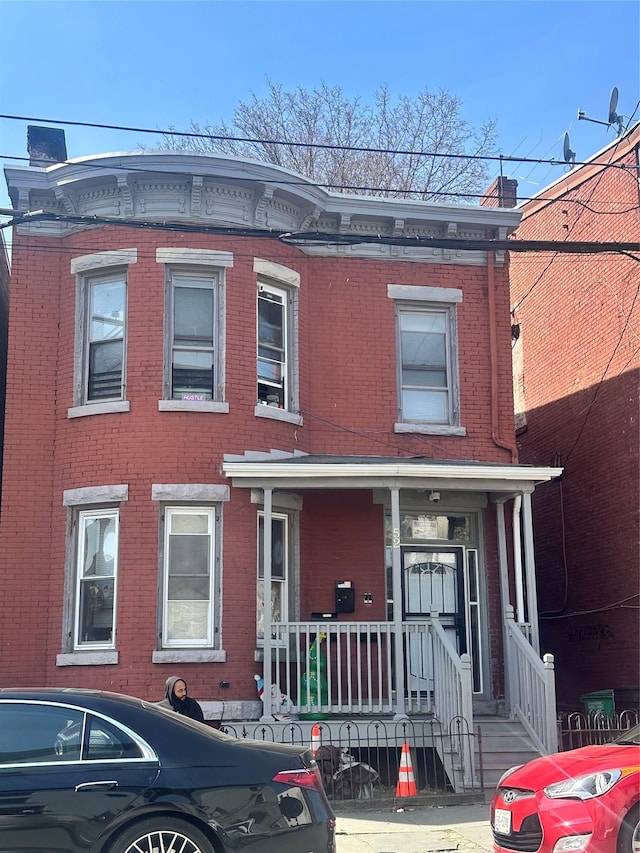 52 Lander St, Newburgh, NY 12550 - view of front of home with brick siding and covered porch