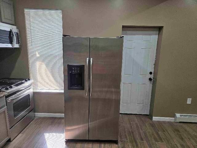 52 Lander St, Newburgh, NY 12550 - kitchen featuring stainless steel appliances, baseboards, wood tiled floor, and a baseboard radiator