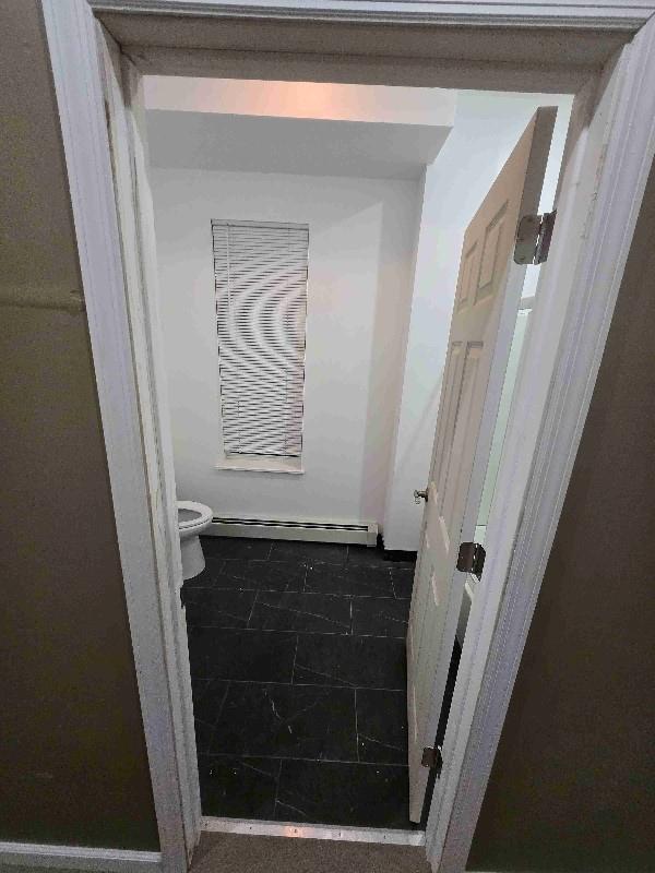 52 Lander St, Newburgh, NY 12550 - bathroom with toilet and a baseboard radiator