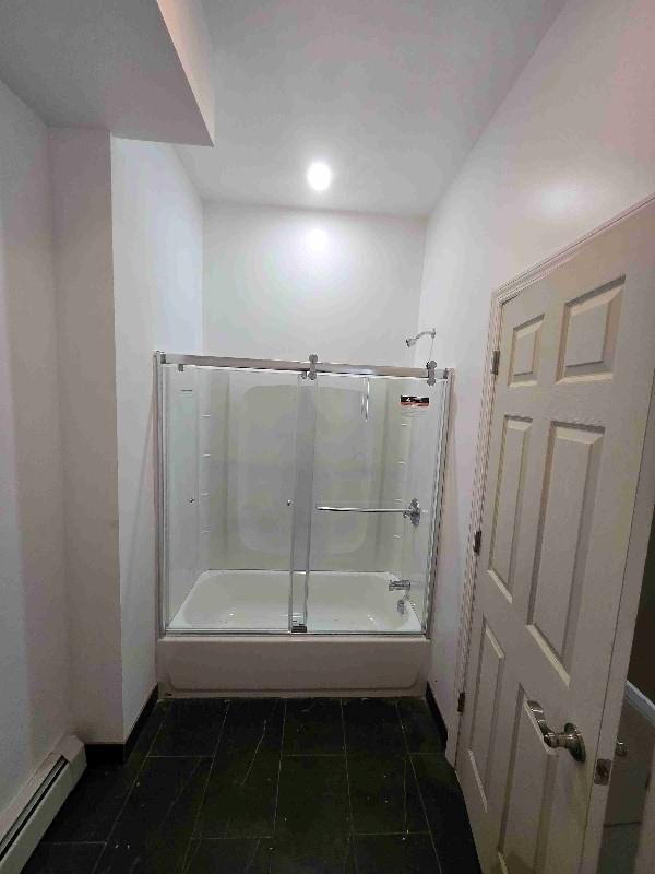 52 Lander St, Newburgh, NY 12550 - full bath with tile patterned flooring, baseboards, bath / shower combo with glass door, and a baseboard radiator