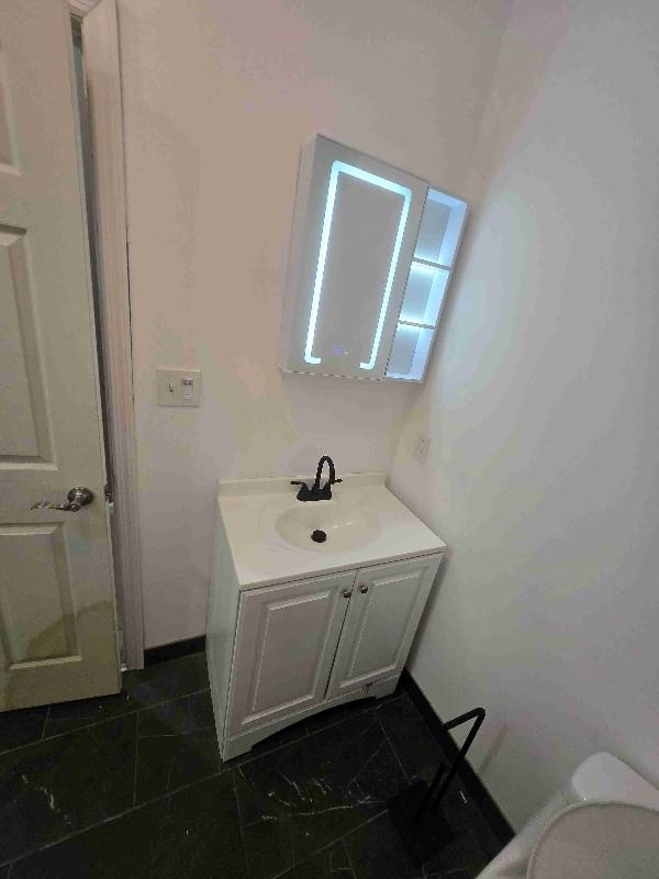 52 Lander St, Newburgh, NY 12550 - half bath featuring baseboards, toilet, and vanity