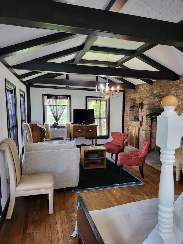 living area with lofted ceiling with beams, ornate columns, a chandelier, and hardwood / wood-style floors