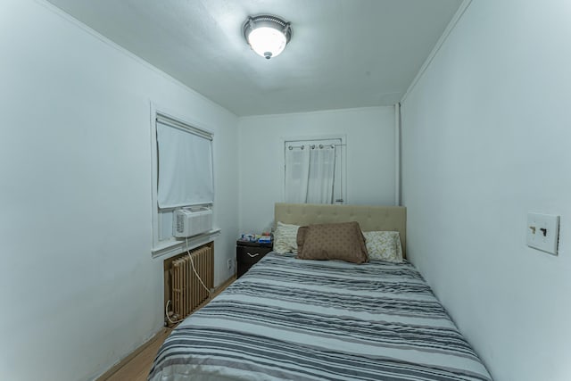 bedroom with radiator heating unit and cooling unit