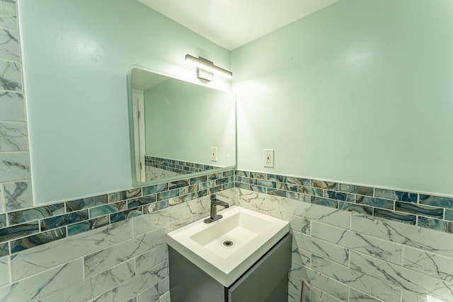 bathroom with tile walls and vanity