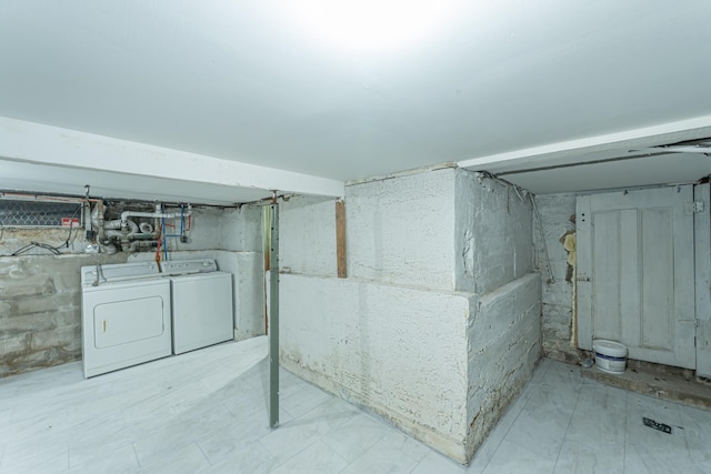 unfinished below grade area featuring separate washer and dryer