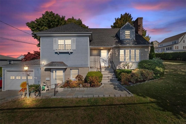 view of front of property featuring a garage, a front yard, and a chimney