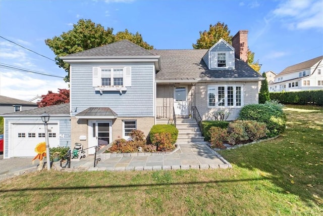 view of front of home featuring a front yard, a chimney, and an attached garage