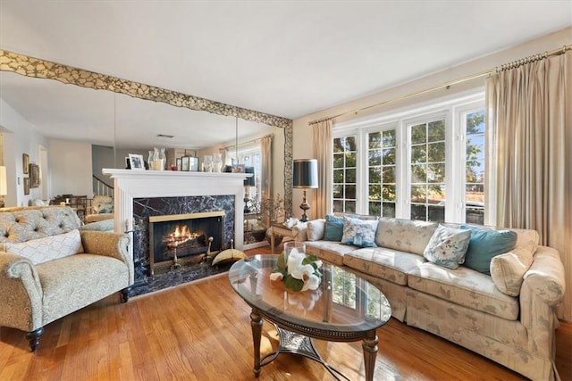 living area with a fireplace and wood finished floors