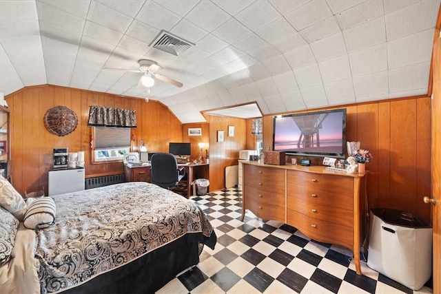 bedroom featuring lofted ceiling, radiator heating unit, visible vents, and tile patterned floors