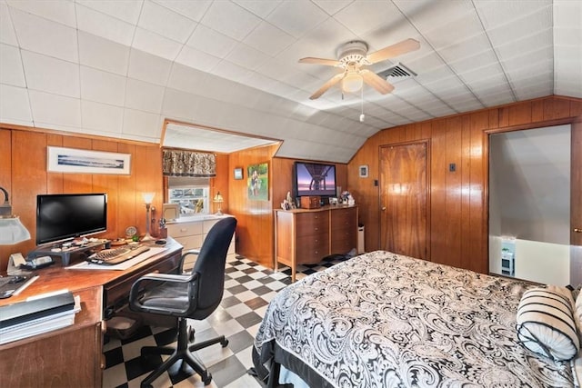 bedroom featuring lofted ceiling, wooden walls, and tile patterned floors