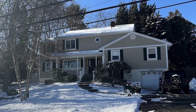 view of front of house featuring a porch and a garage