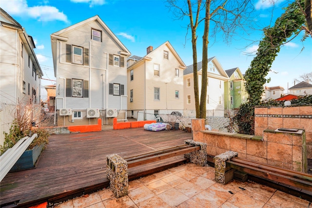 rear view of property with fence, a wooden deck, ac unit, a patio area, and a residential view