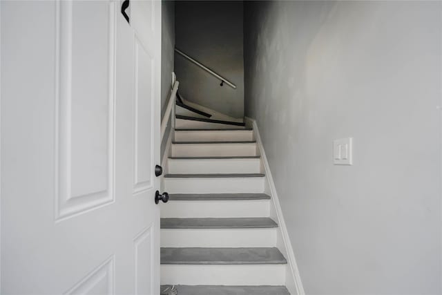 stairway featuring baseboards