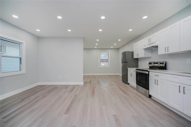 kitchen featuring under cabinet range hood, white cabinets, light wood finished floors, and stainless steel appliances