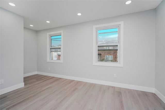 spare room with recessed lighting, baseboards, and wood finished floors