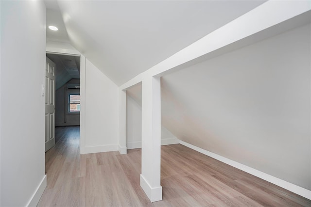 bonus room featuring lofted ceiling, wood finished floors, and baseboards