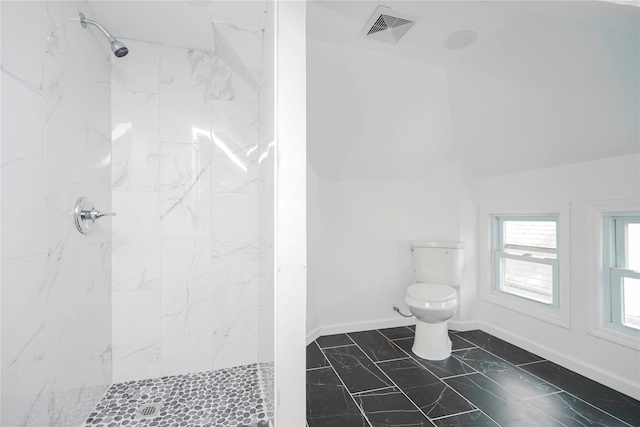 bathroom with vaulted ceiling, toilet, visible vents, and walk in shower