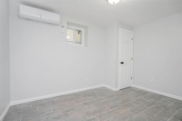 empty room with baseboards and a wall mounted AC