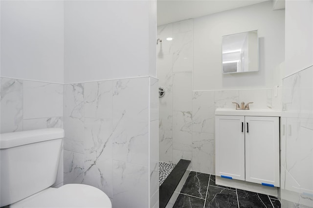 full bath with a walk in shower, toilet, vanity, marble finish floor, and tile walls