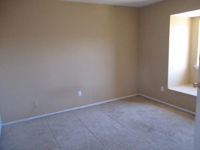 spare room with baseboards