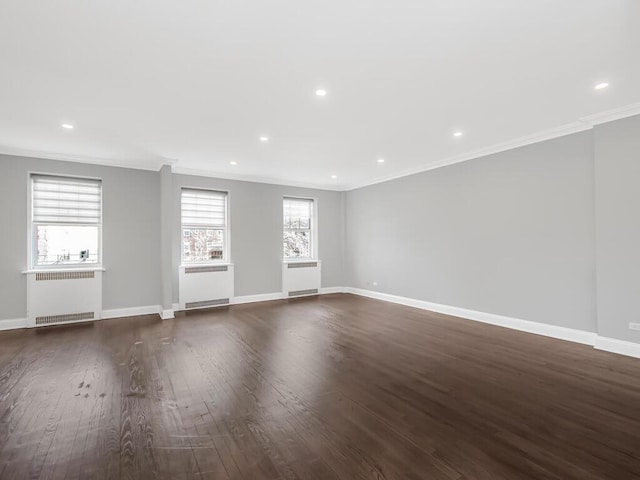 interior space featuring radiator, baseboards, wood finished floors, and ornamental molding