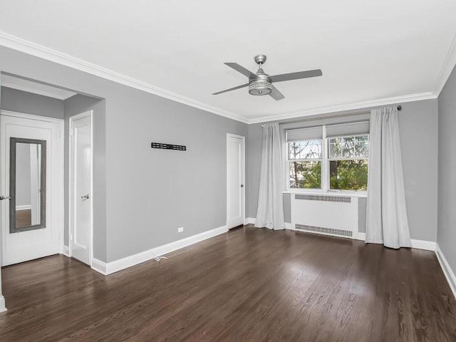 empty room featuring baseboards, ceiling fan, radiator heating unit, dark wood-style flooring, and crown molding