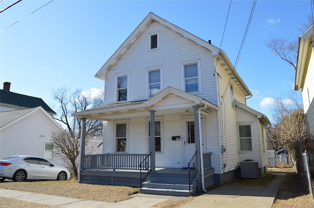 view of front of house with cooling unit and a porch