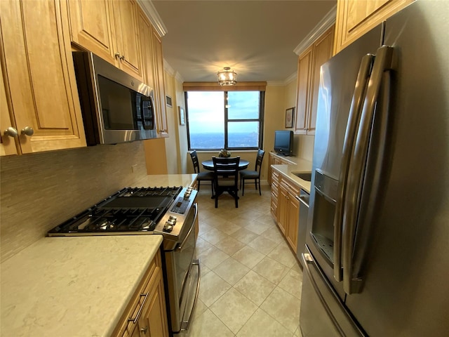 kitchen featuring light tile patterned floors, appliances with stainless steel finishes, ornamental molding, light countertops, and backsplash