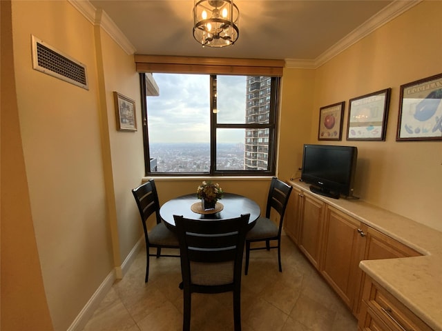 dining room with baseboards, visible vents, a chandelier, and ornamental molding