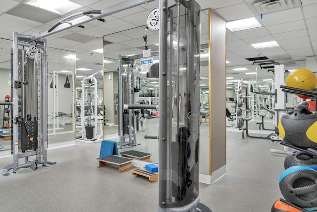 gym featuring a paneled ceiling and visible vents