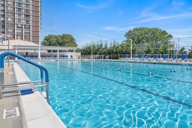 community pool featuring a patio area, fence, and a pergola