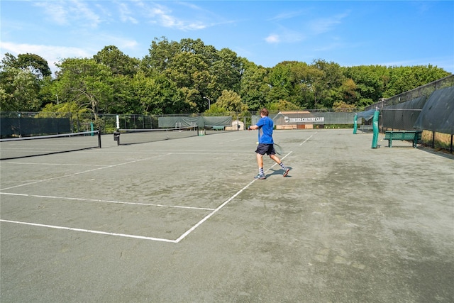 view of tennis court featuring fence