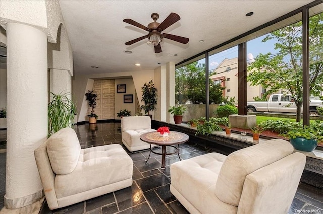 sunroom featuring ceiling fan