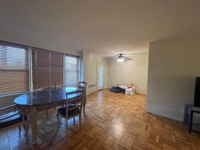 dining room featuring a ceiling fan and baseboards