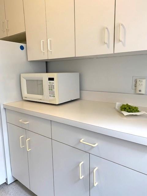 details featuring white microwave and light countertops