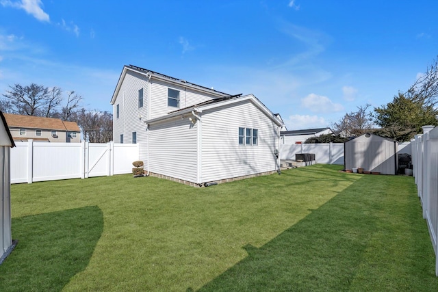 rear view of property with a fenced backyard, an outdoor structure, a storage unit, and a lawn