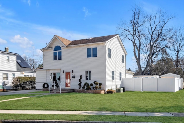 view of front facade featuring a front yard, fence, and cooling unit