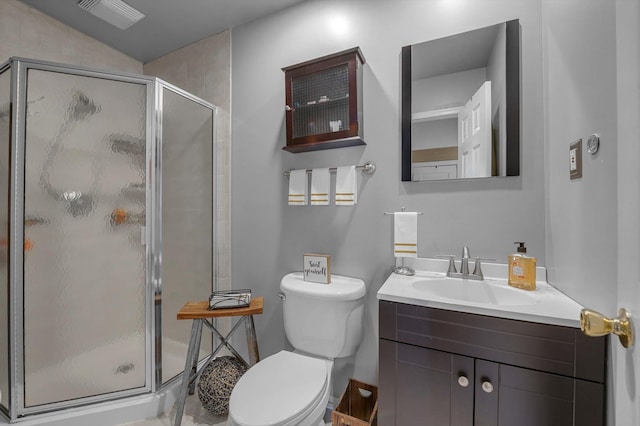 bathroom featuring a stall shower, visible vents, vanity, and toilet