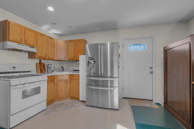 kitchen with stainless steel fridge with ice dispenser, light floors, white gas range, light countertops, and under cabinet range hood