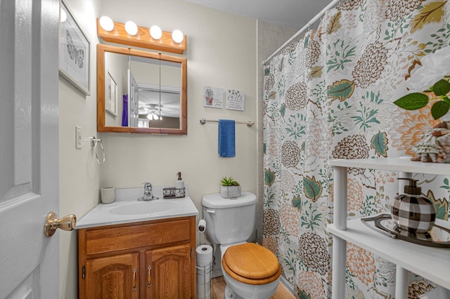 full bath featuring curtained shower, vanity, and toilet